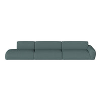 Modern teal sectional sofa with a textured fabric pattern, featuring smooth curves and a minimalist design.