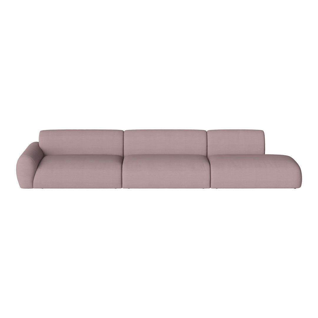 Soft pink sectional sofa with a minimalist design and smooth fabric, perfect for modern living spaces.