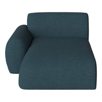 Teal upholstered lounge chair with a subtle textured pattern, featuring smooth, modern lines and a rounded armrest.