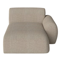 Beige upholstered chaise lounge with a textured, woven pattern and soft, rounded edges. Ideal for modern decor.