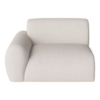 Light beige textured sofa with a modern design and softly curved lines for a minimalist aesthetic.