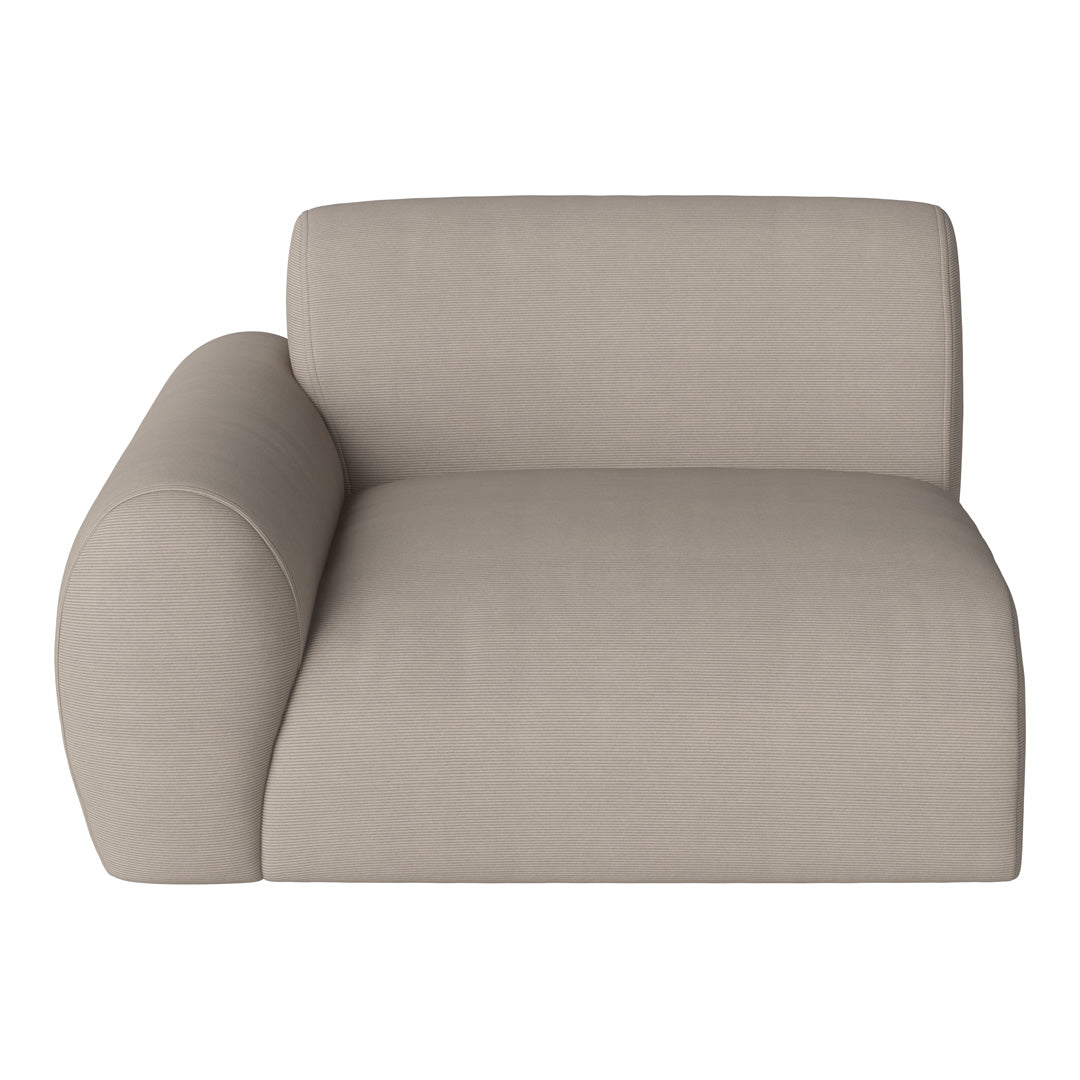 Beige ribbed lounge chair with a curved armrest, showcasing a minimalist and modern design for elegant interiors.