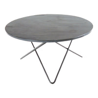 Round black metal table with a minimalist design and sleek, modern tripod base. Ideal for contemporary interiors.