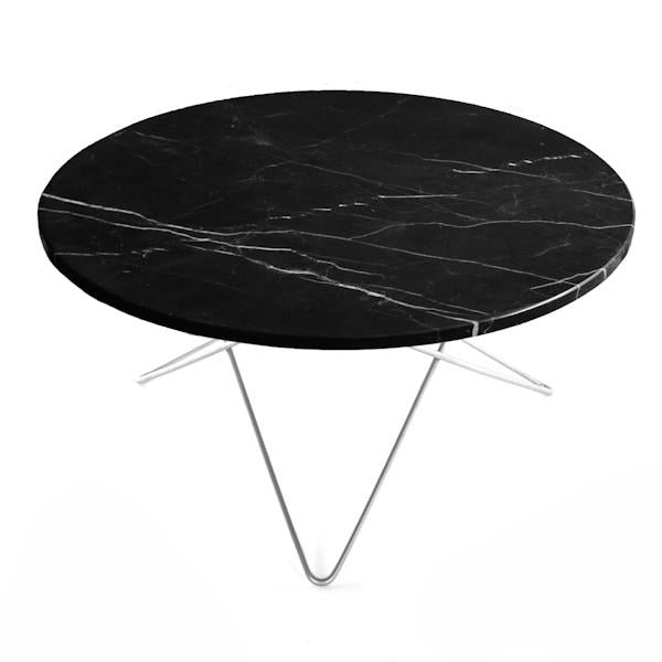 Round black marble table with white veining and sleek metal legs, perfect for modern decor.