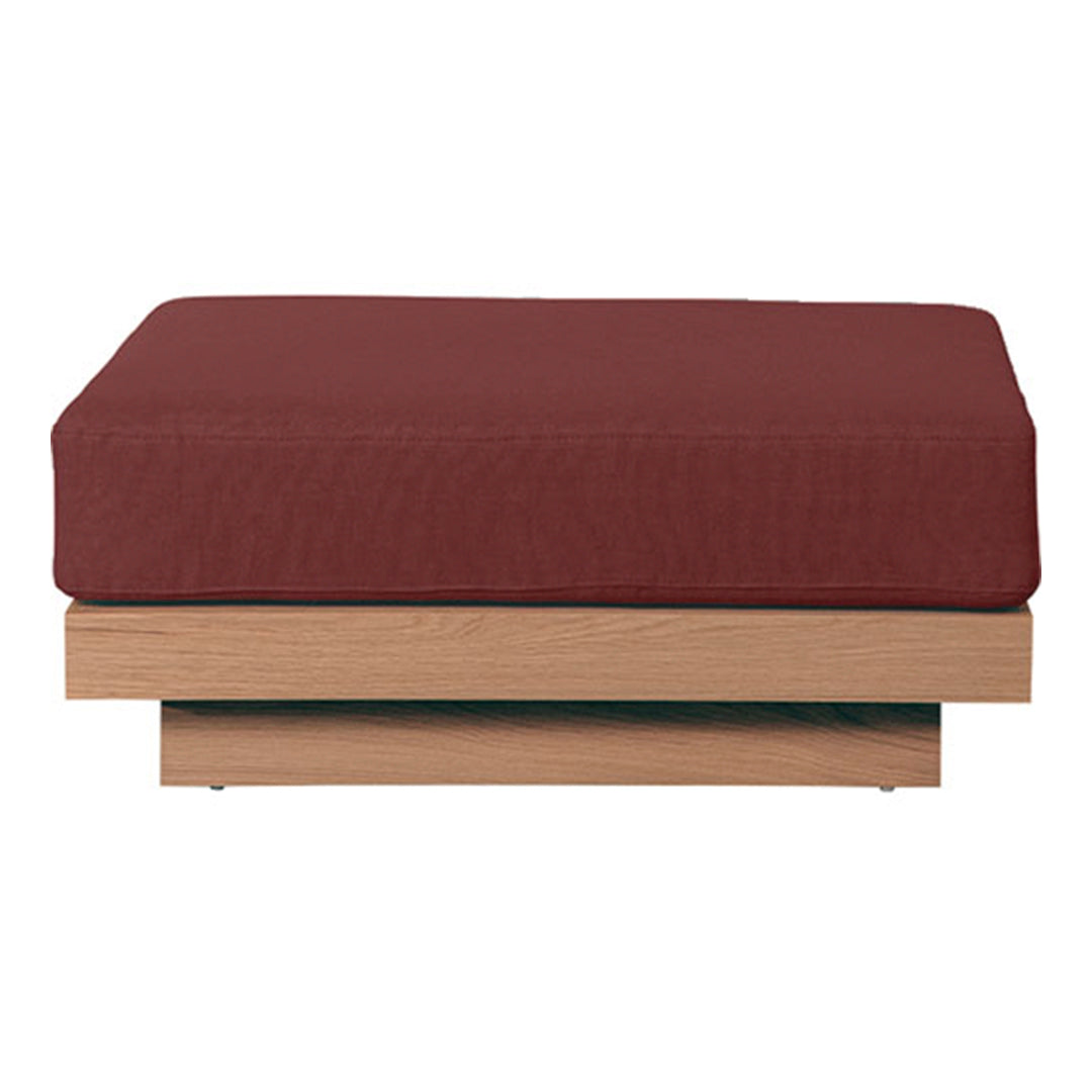 Rust red cushion on a light wood base, featuring a simple, modern design with clean lines. Perfect for contemporary decor.