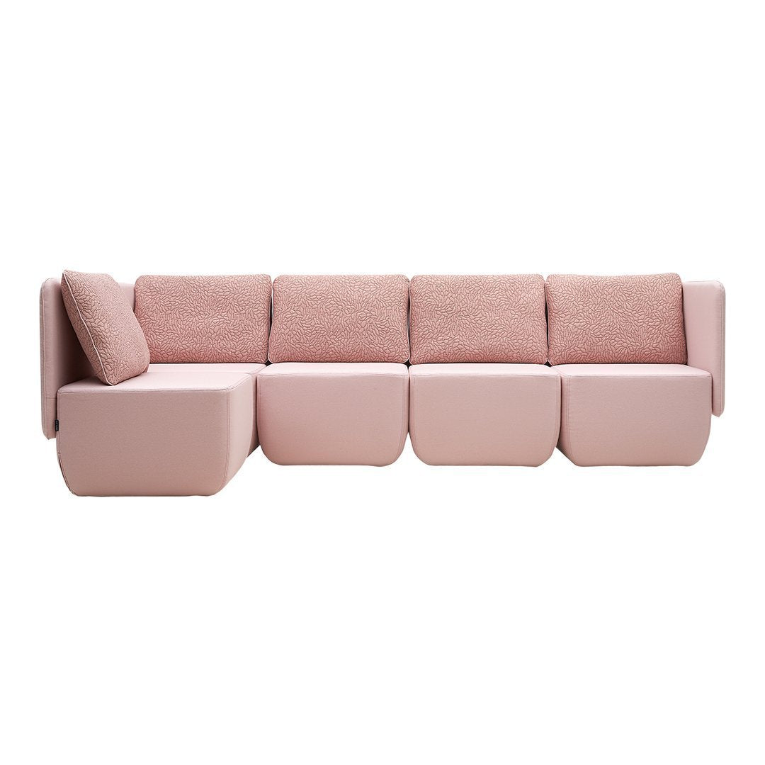 Soft pink modular sofa with smooth surfaces and plush cushions, featuring a contemporary, minimalist design.