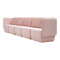 Blush pink sofa with plush, textured pillows and a minimalist design, ideal for modern home decor.
