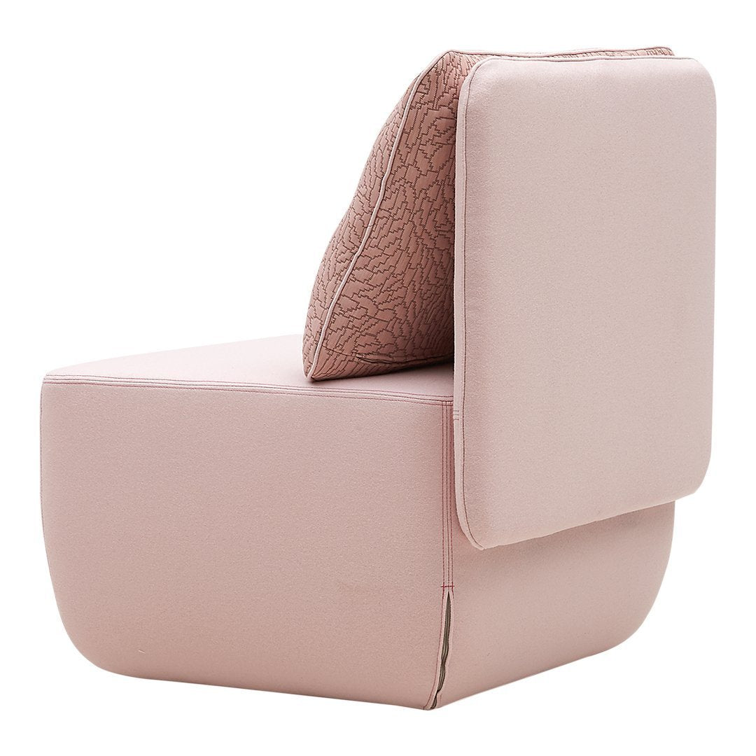 Blush pink upholstered chair with a textured, light brown patterned back cushion for a contemporary look.