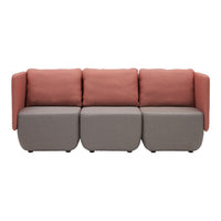Modern sofa featuring soft pink cushions and a sleek gray base, accentuating a minimalist style.