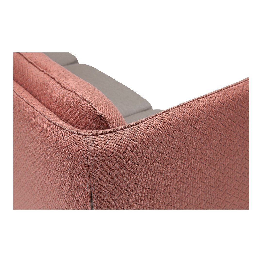 Textured pink upholstery with geometric pattern and gray accents, ideal for modern interior design.