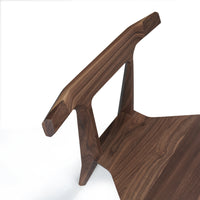 Elegant walnut wood chair with rich dark brown hues and smooth, natural wood grain patterns. Ideal for modern decor.