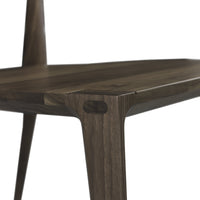 Dark walnut wood table with smooth finish and angled legs, showcasing natural grain patterns.
