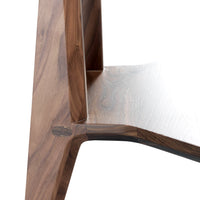 Walnut wood table showcasing rich brown tones and smooth, natural grain patterns. Stylish and modern design.