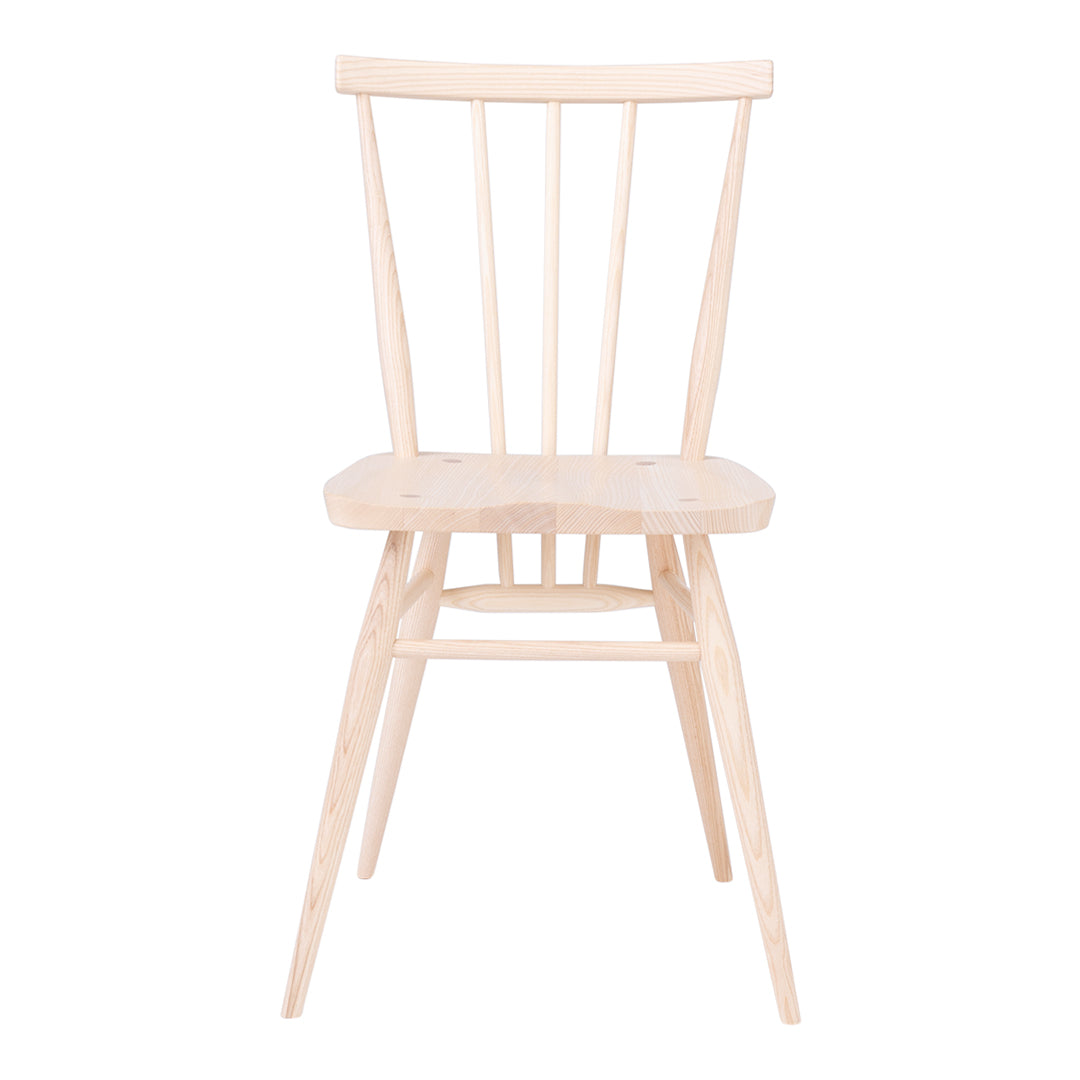 Light natural wood chair with a minimalist design, featuring subtle grain patterns and a neutral finish.