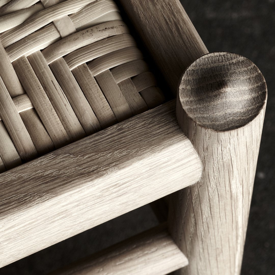 Close-up of a woven natural wood pattern with light oak tones and smooth rounded edges. Perfect for rustic decor.