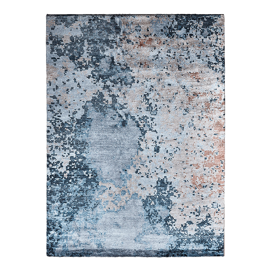 Abstract blue and gray area rug with textured patterns and hints of copper accents. Perfect for modern decor.