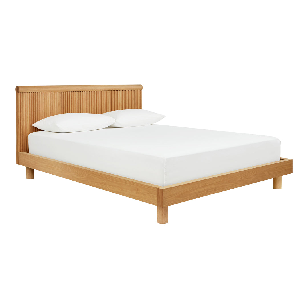 Natural wood finish with light beige accents; minimalist design and white bedding create a modern, clean look.