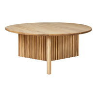 Round wooden coffee table featuring a natural finish and vertical ribbed pattern on the base.