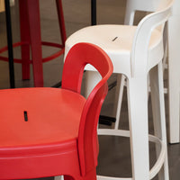 Red and white bar stools with sleek patterns, highlighting vibrant urban decor style. Perfect for modern spaces.