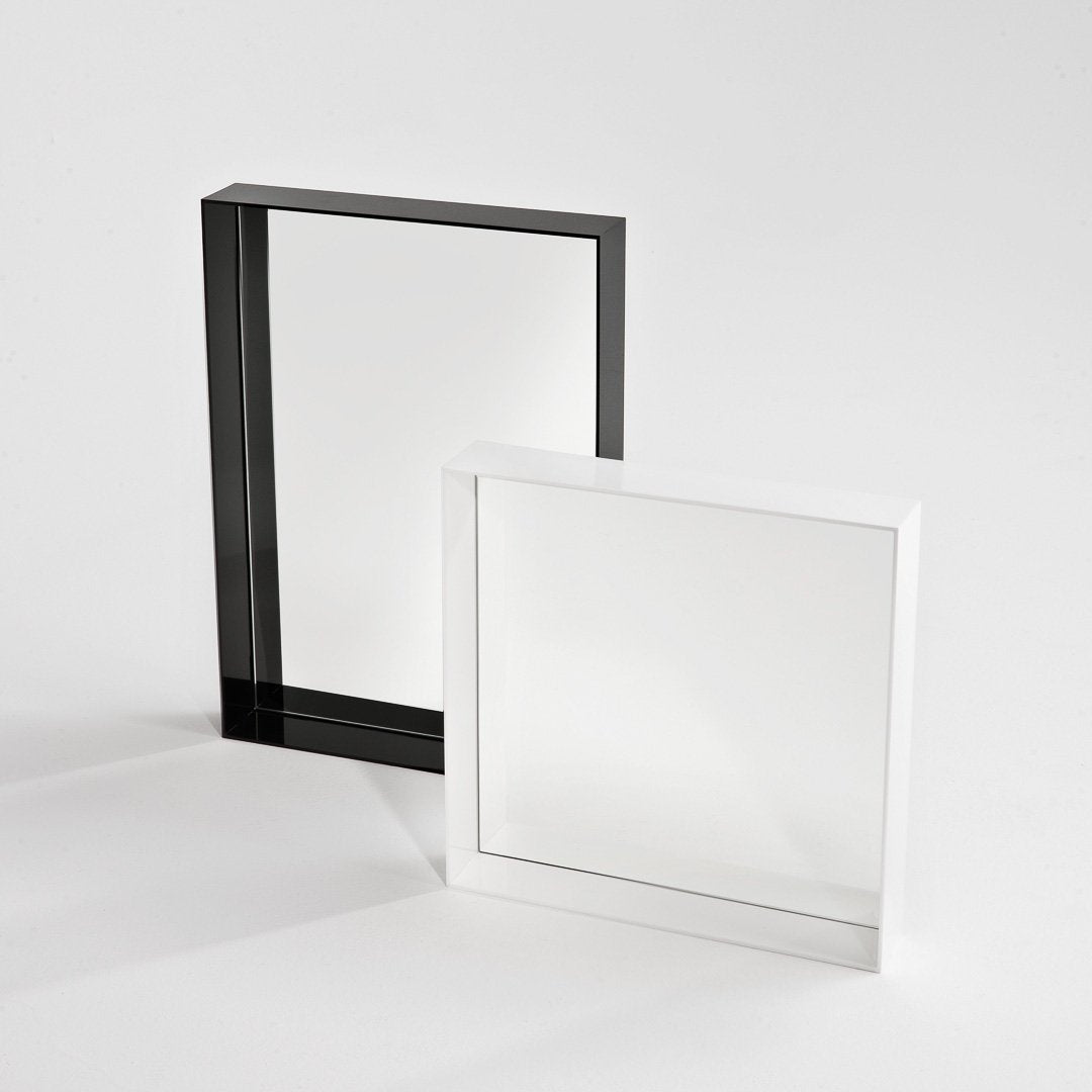 Black and white square picture frames with sleek, modern designs on a neutral background.