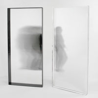 "Modern black and clear glass mirrors with sleek, minimalist design, showcasing reflective surfaces and subtle patterns."