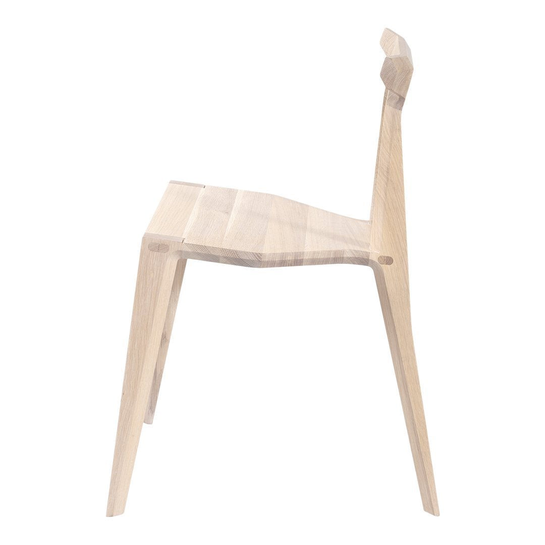 Natural wood chair with a light finish and minimalist design. Smooth, simple lines and a clean aesthetic.