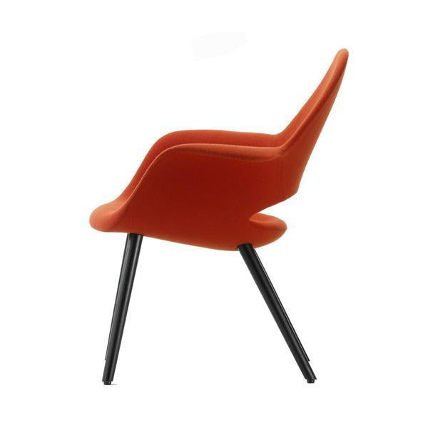 Orange modern chair with smooth curves and sleek black legs, perfect for stylish home decor.