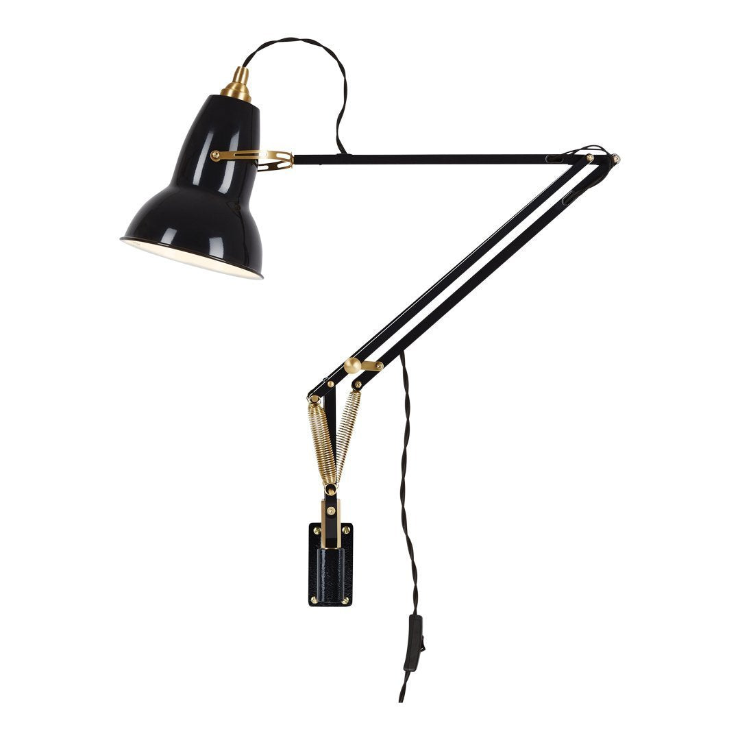 Black and gold adjustable desk lamp with a sleek, modern design and striped power cord. Ideal for stylish interiors.