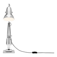 Silver metallic desk lamp with a sleek, modern design and white shade, featuring a clear base and black cord.
