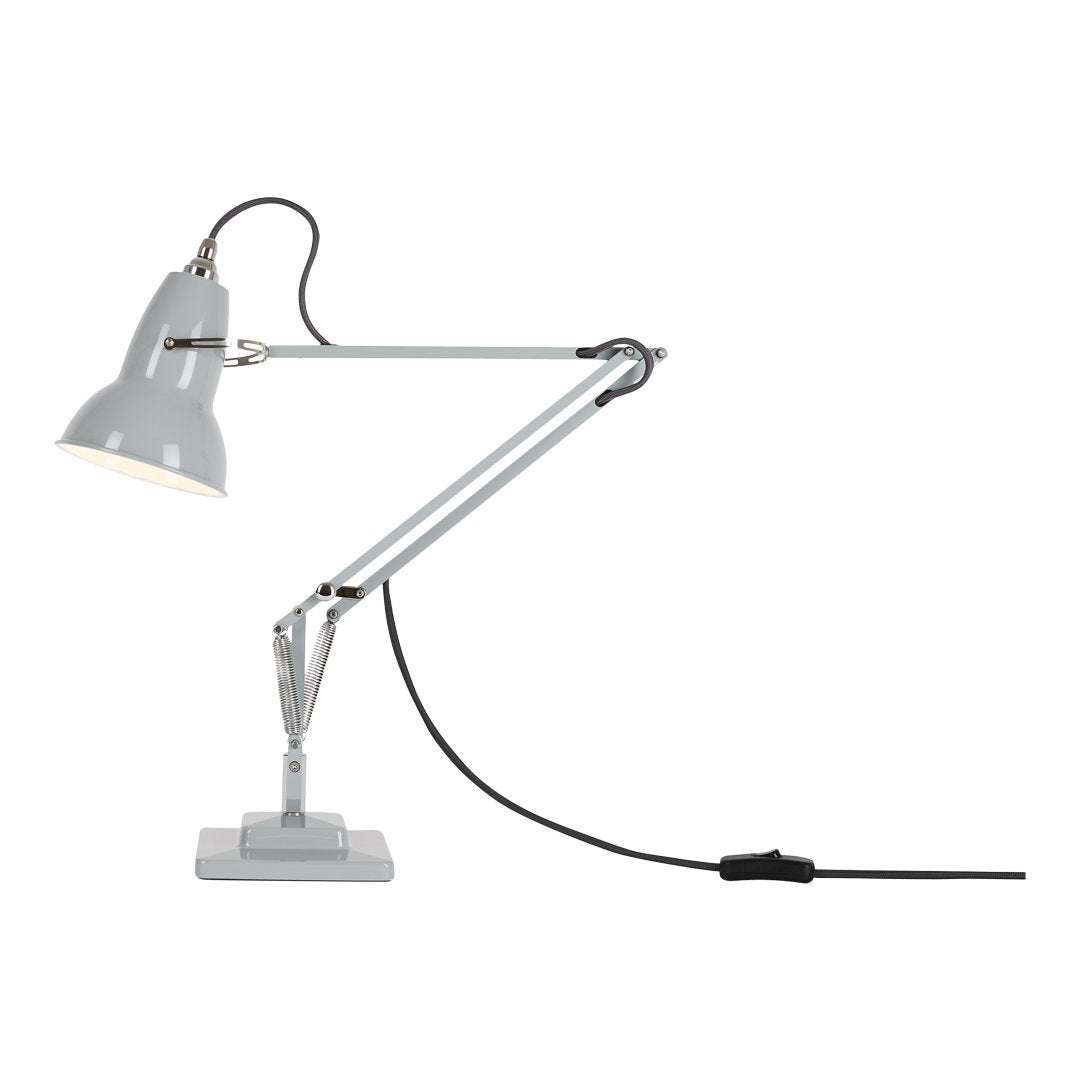 Grey desk lamp with a minimalist design, featuring a smooth metal finish and a sleek, adjustable arm.