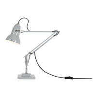 Grey desk lamp with a minimalist design, featuring a smooth metal finish and a sleek, adjustable arm.