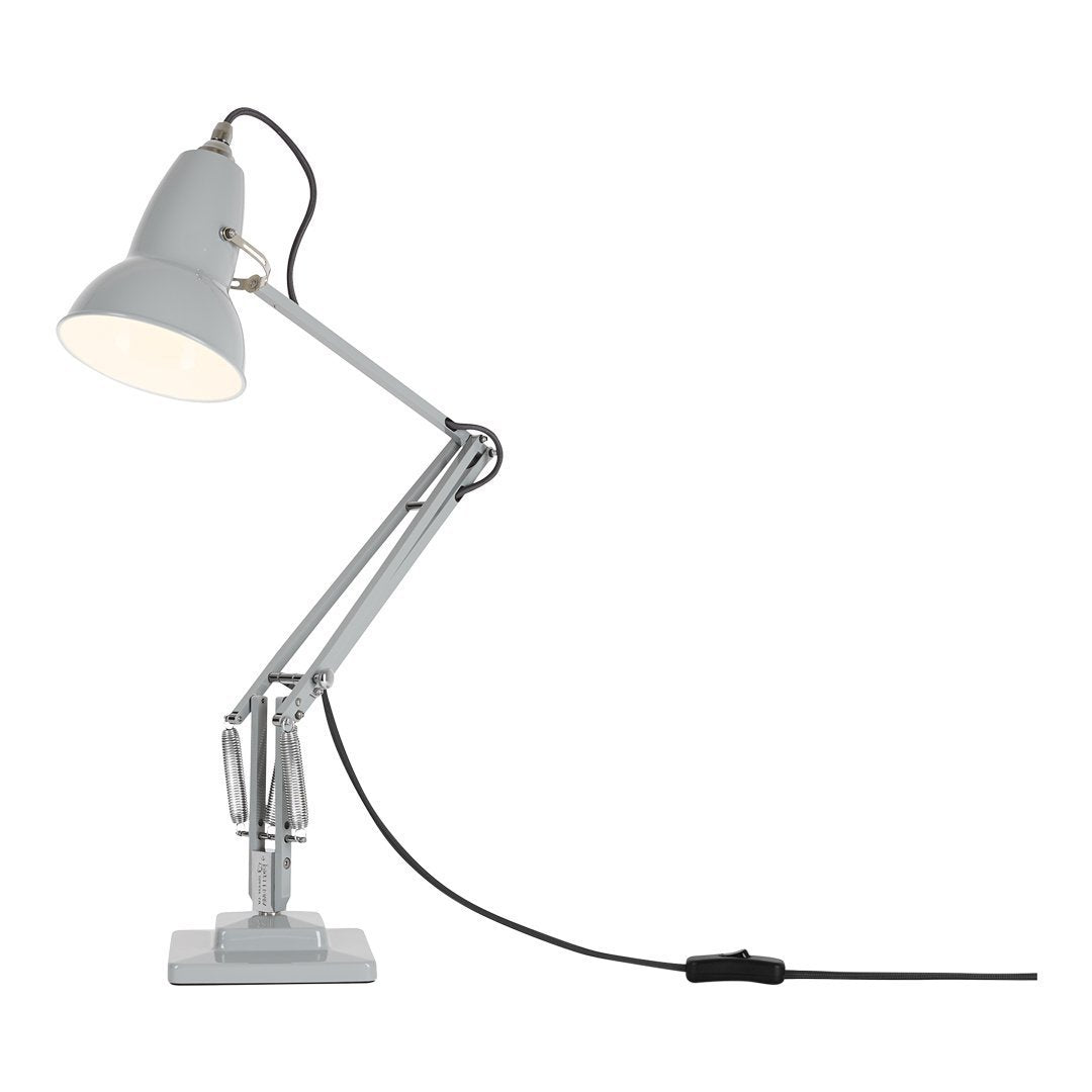 Gray adjustable desk lamp with a sleek metallic finish and contrasting white shade, featuring a minimalist design.