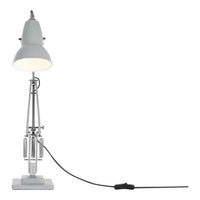 White industrial lamp with a sleek metallic base and a black cord, featuring minimalistic design and modern aesthetics.