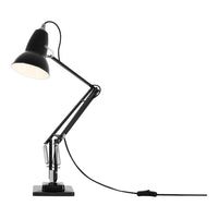 Black angled desk lamp with a glossy finish and a solid black base, featuring a sleek, modern design.