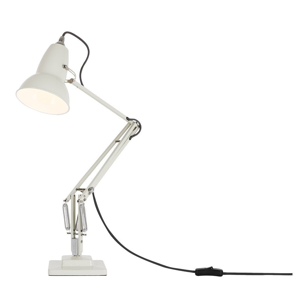 White adjustable desk lamp with a modern design and minimalist style. Features a smooth finish and black cord accents.