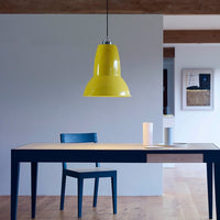 Bright yellow pendant lamp over a sleek blue table and chair, featuring clean lines and modern minimalist design.