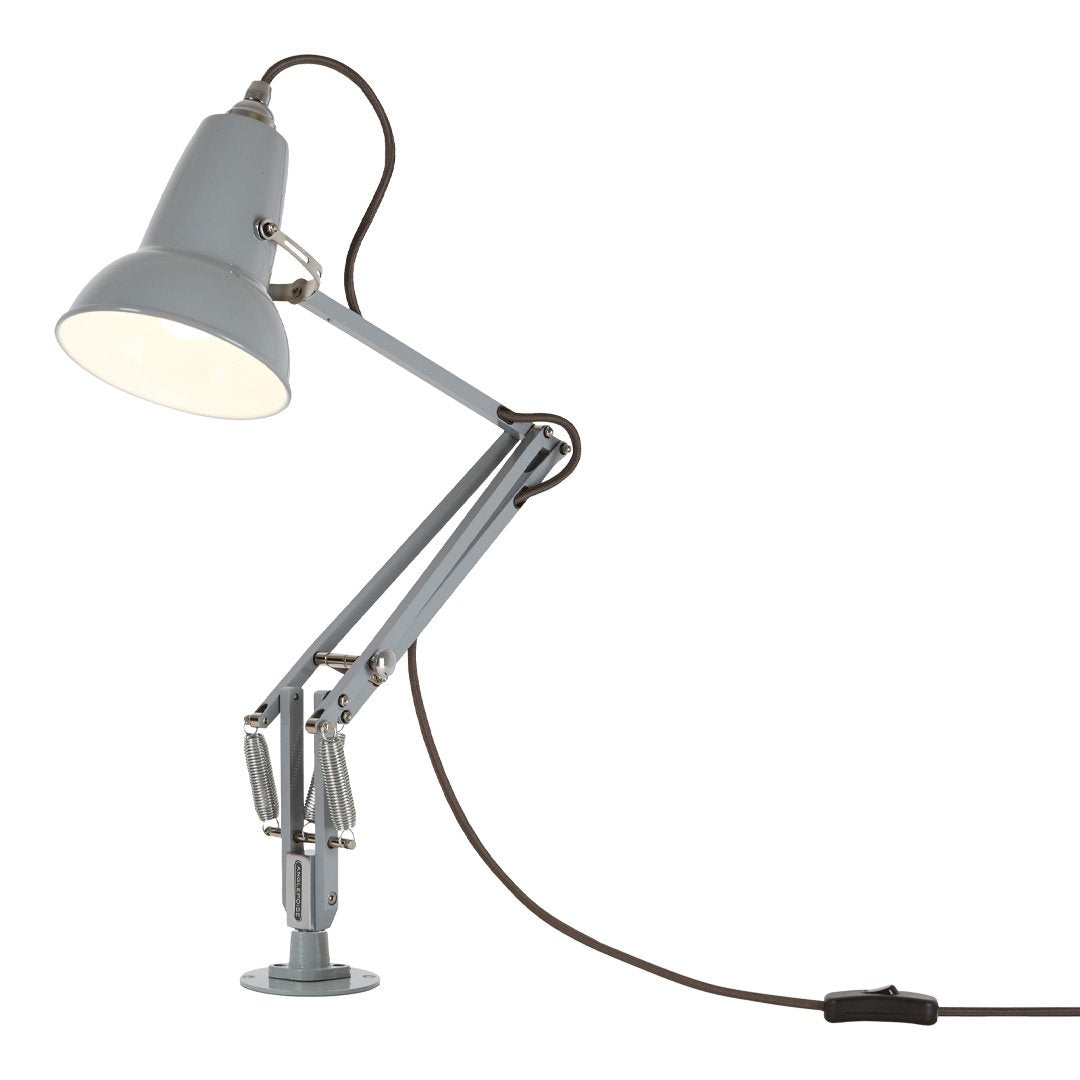 Gray adjustable desk lamp with a sleek design and brown power cord. Modern and minimalist style for any workspace.