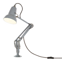 Gray adjustable desk lamp with a sleek design and brown power cord. Modern and minimalist style for any workspace.