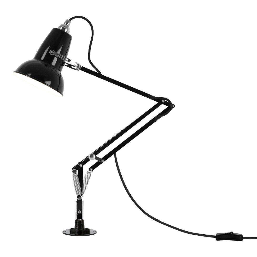 Black metal desk lamp with sleek adjustable arm and chrome accents, showcasing a minimalist design.