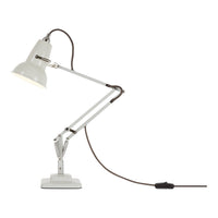 White metal desk lamp with a sleek silver arm and brown cord, featuring a minimalist design and classic industrial style.