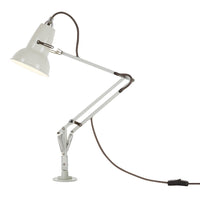 White adjustable desk lamp with metal finish and brown cord, featuring sleek, modern lines and minimalistic design.