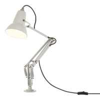 White adjustable desk lamp with a sleek metal body and a brown cord, featuring a minimalist design.