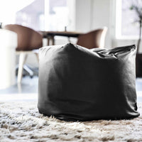 Black bean bag chair with a sleek, minimalist design, perfect for modern interiors. Soft texture, no patterns.