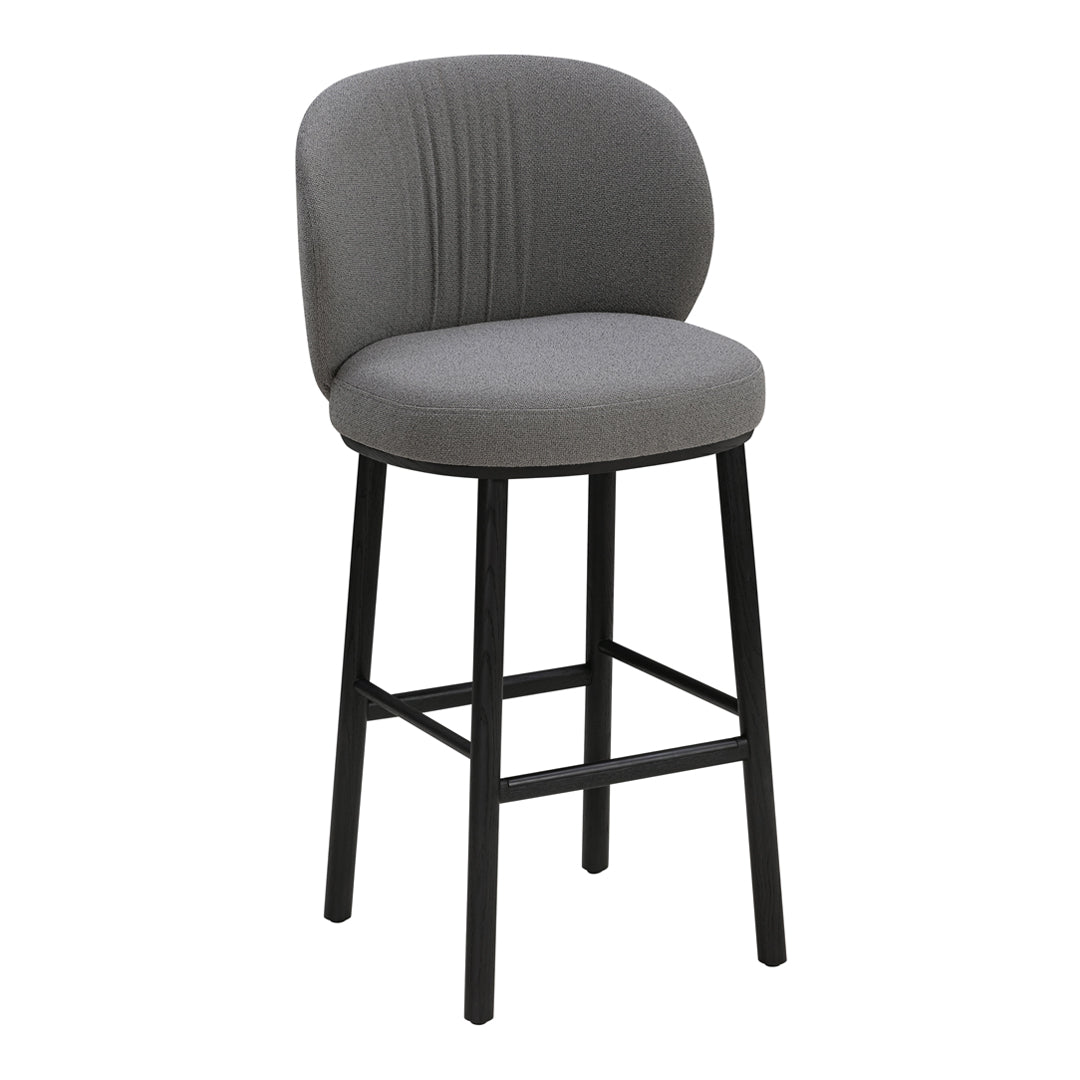 Gray upholstered bar stool with a curved backrest and sleek black wooden legs, featuring subtle vertical stitching.