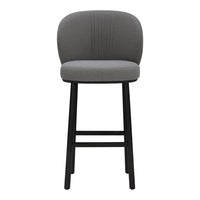 Gray upholstered bar stool with ribbed pattern and sleek black wooden legs. Modern and stylish home decor.