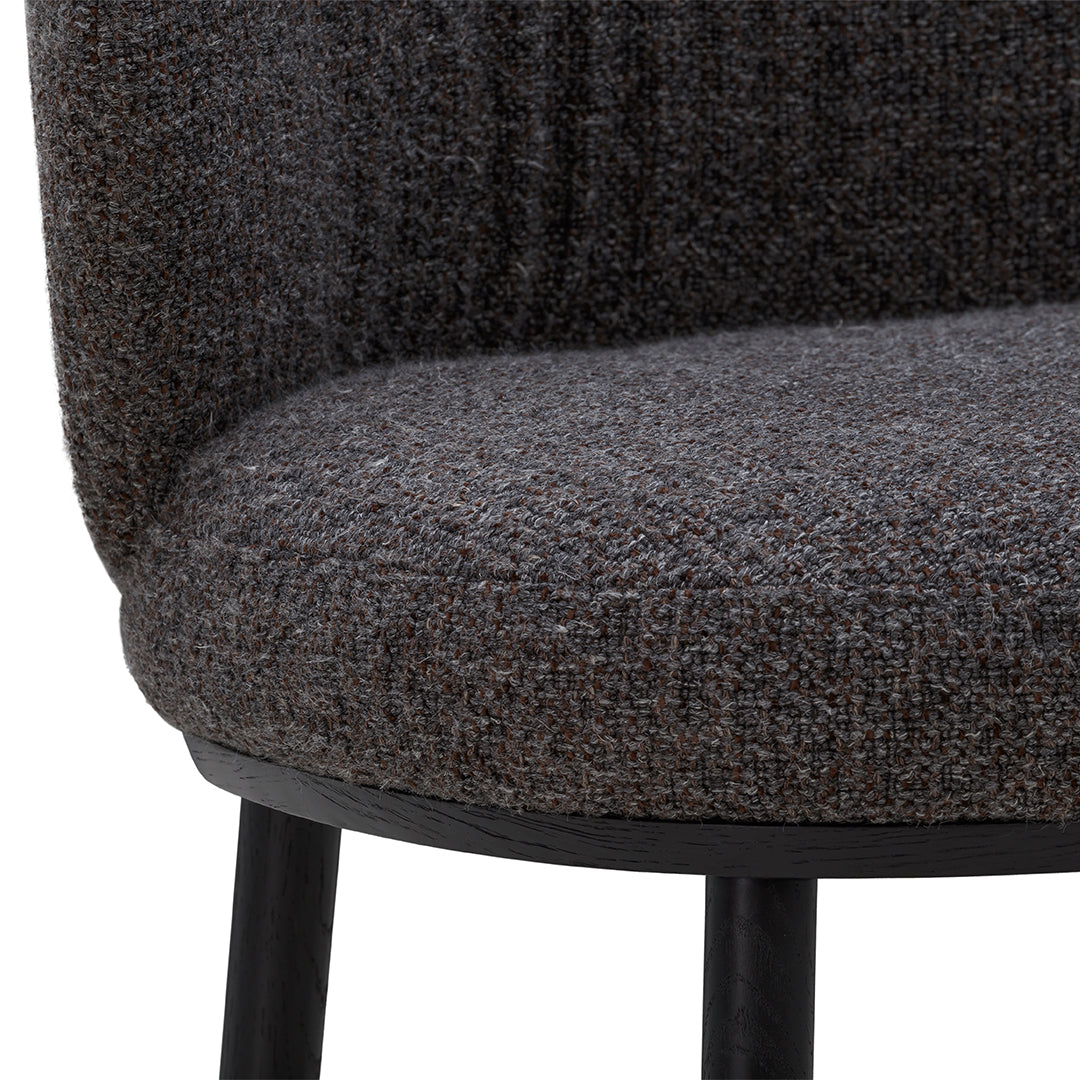 Dark gray textured upholstery with subtle flecks of brown in a modern chair design.
