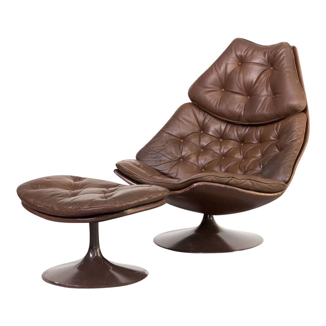 Brown tufted lounge chair with matching ottoman, featuring smooth curves and a glossy base for a modern aesthetic.