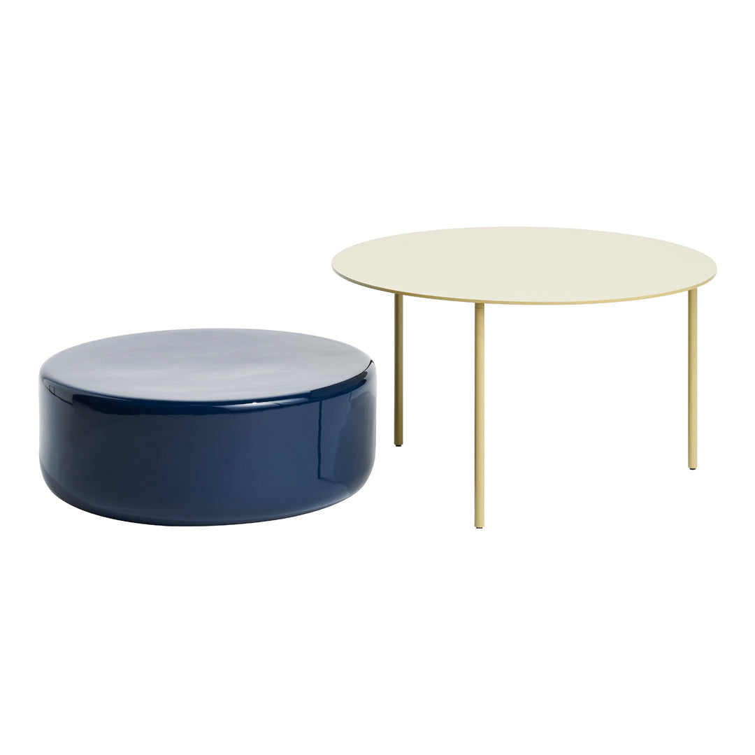 Set of two modern tables featuring a navy blue circular design and a round cream tabletop with gold legs.