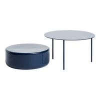 Navy blue round coffee table and matching ottoman with modern, smooth surfaces and minimalistic design.