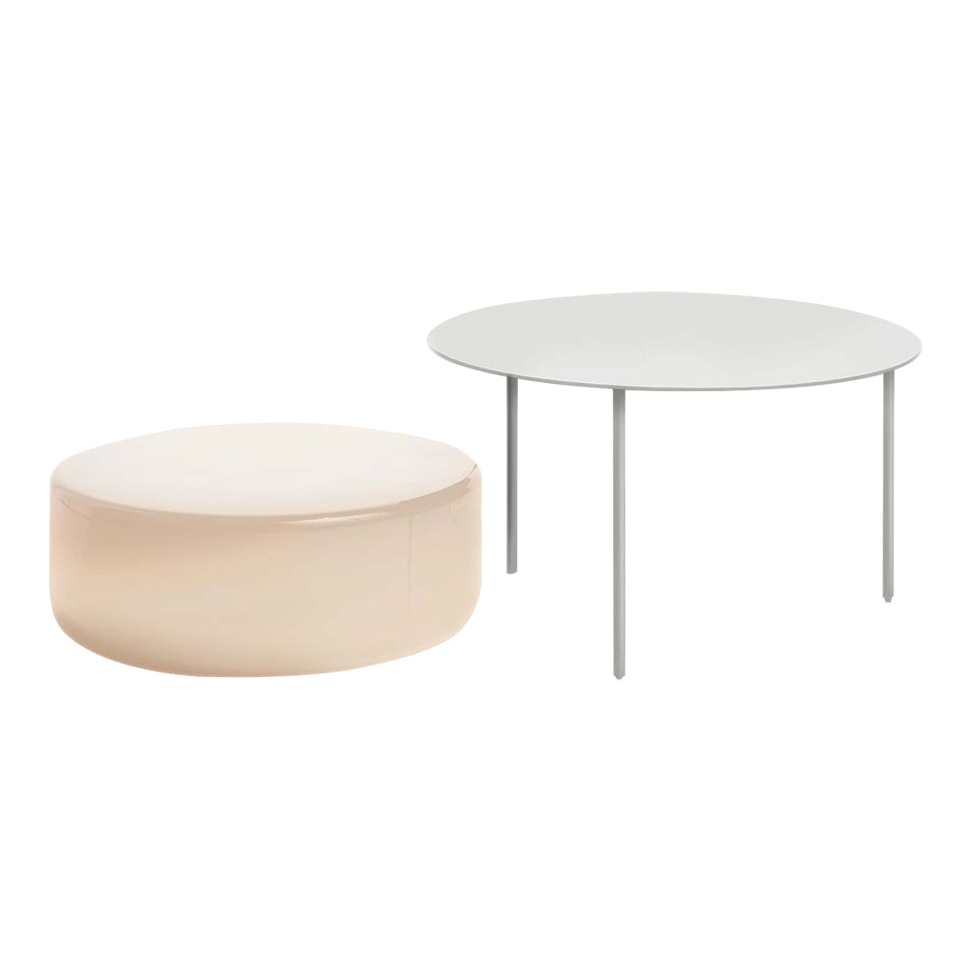 Round coffee tables in soft blush and sleek white finishes with minimalistic designs.